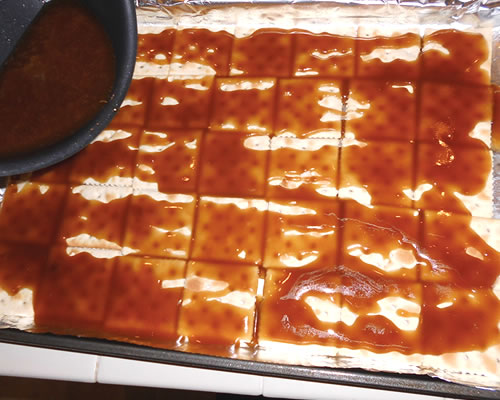 Pour the buttery spread mixture over the saltine crackers; bake in the oven at 375 degrees for 5 minutes.