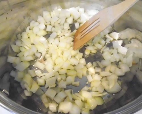 In a large pan, saute the onions in the olive oil for approximately 10 minutes over medium high heat.